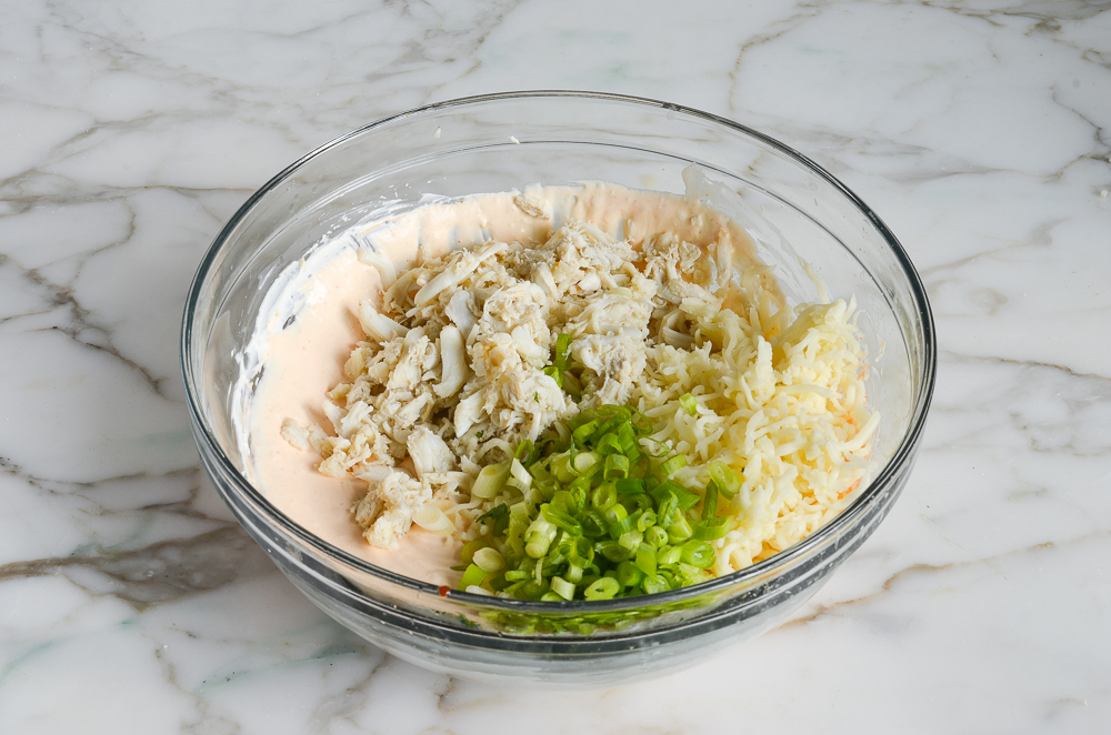 adding crab, scallions, and cheese to dip mixture