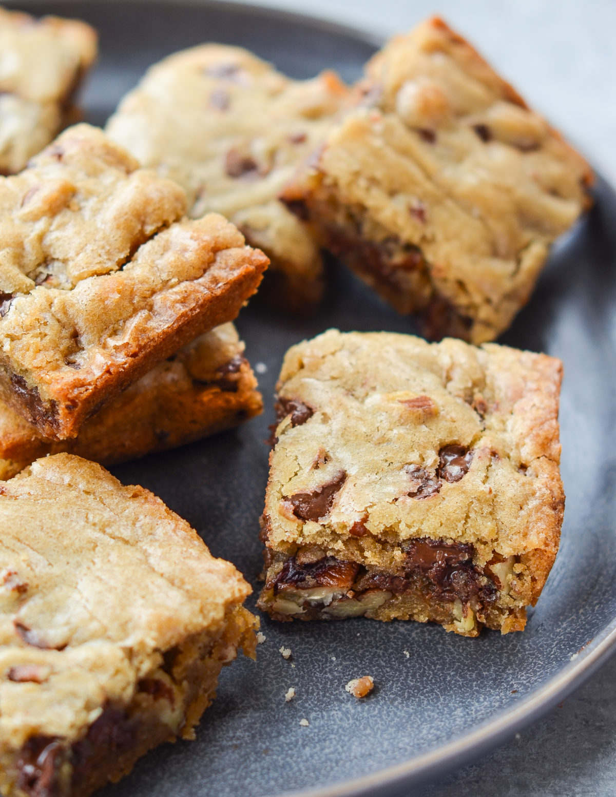 Chocolate chip pecan blondies on a plate.