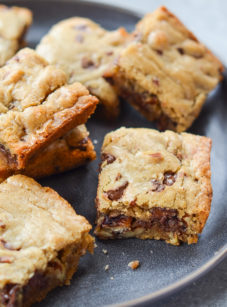 Chocolate chip pecan blondies on a plate.