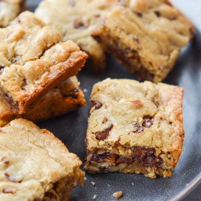 Best blondies with chocolate chips and pecans on a plate.