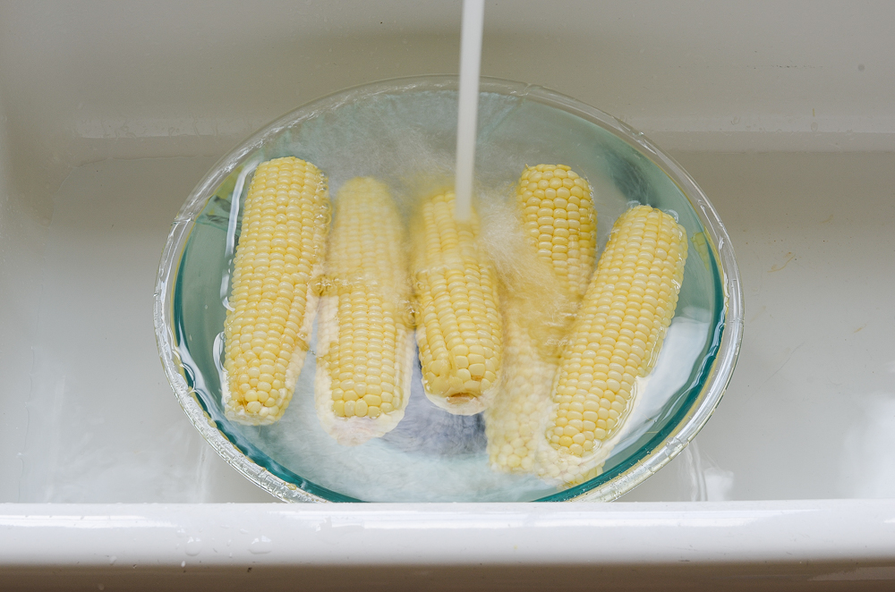 refreshing the corn under cold water