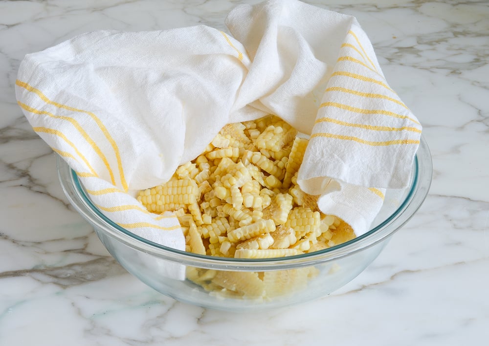 transferring corn to a bowl