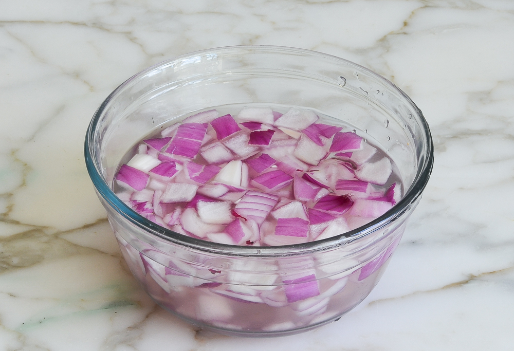 soaking red onions in water for gazpacho salad