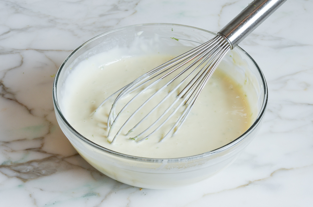 whisked key lime pie filling in mixing bowl