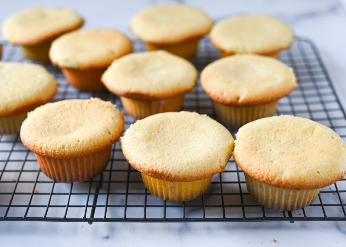 vanilla cupcakes cooling on rack