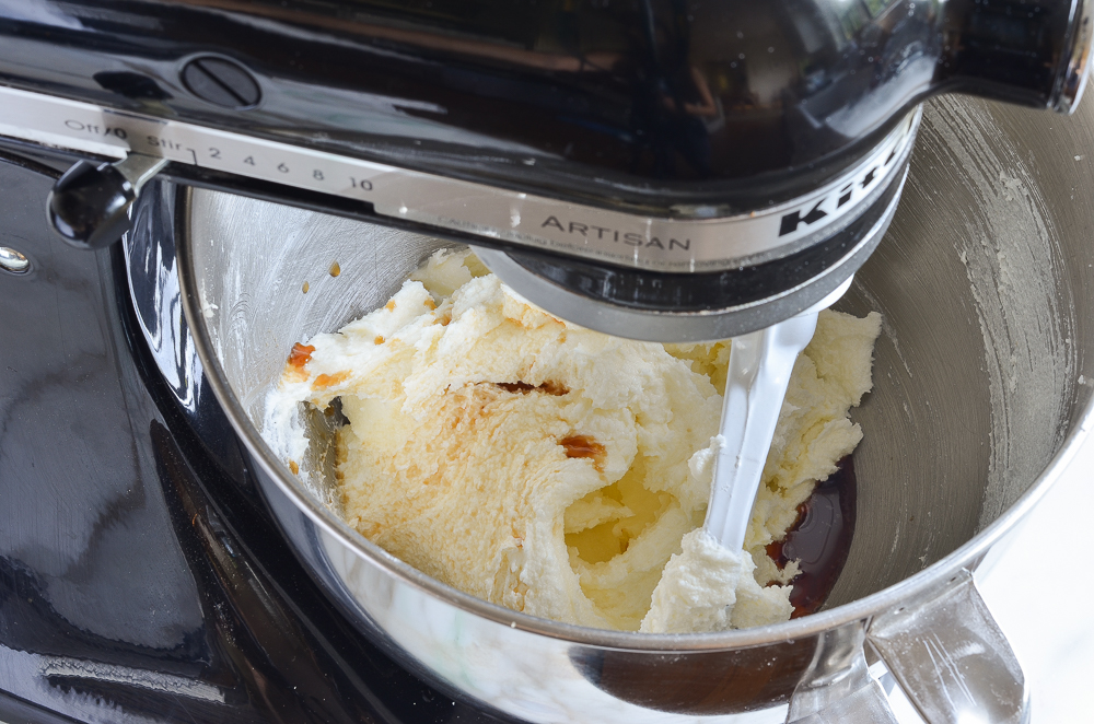 Vanilla added to butter and sugar in a stand mixer.