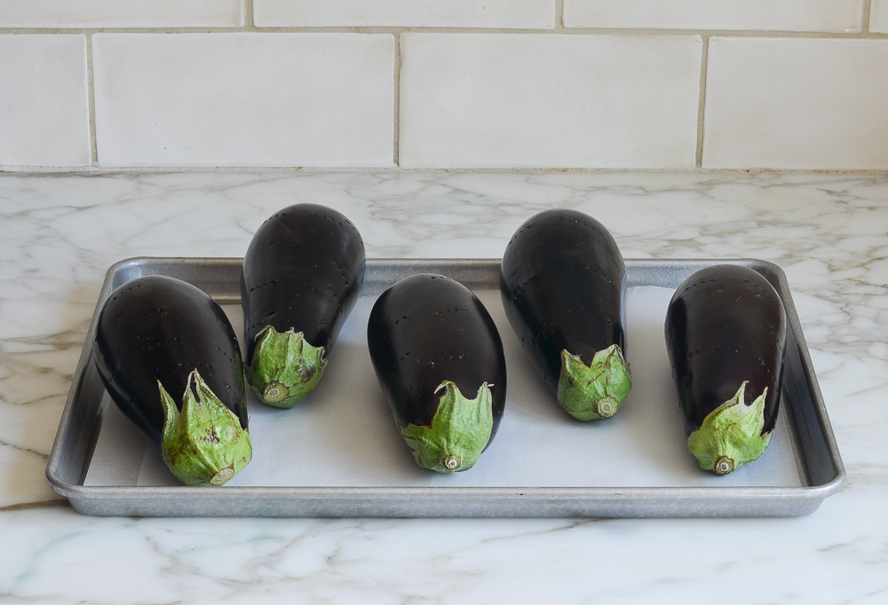poked eggplants on baking sheet