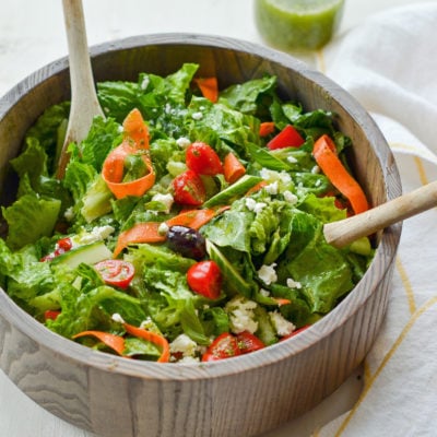 Spoons in a bowl of Italian salad.