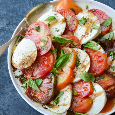 Spoon on a plate with caprese salad.