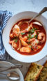 bowl of cioppino with bread.