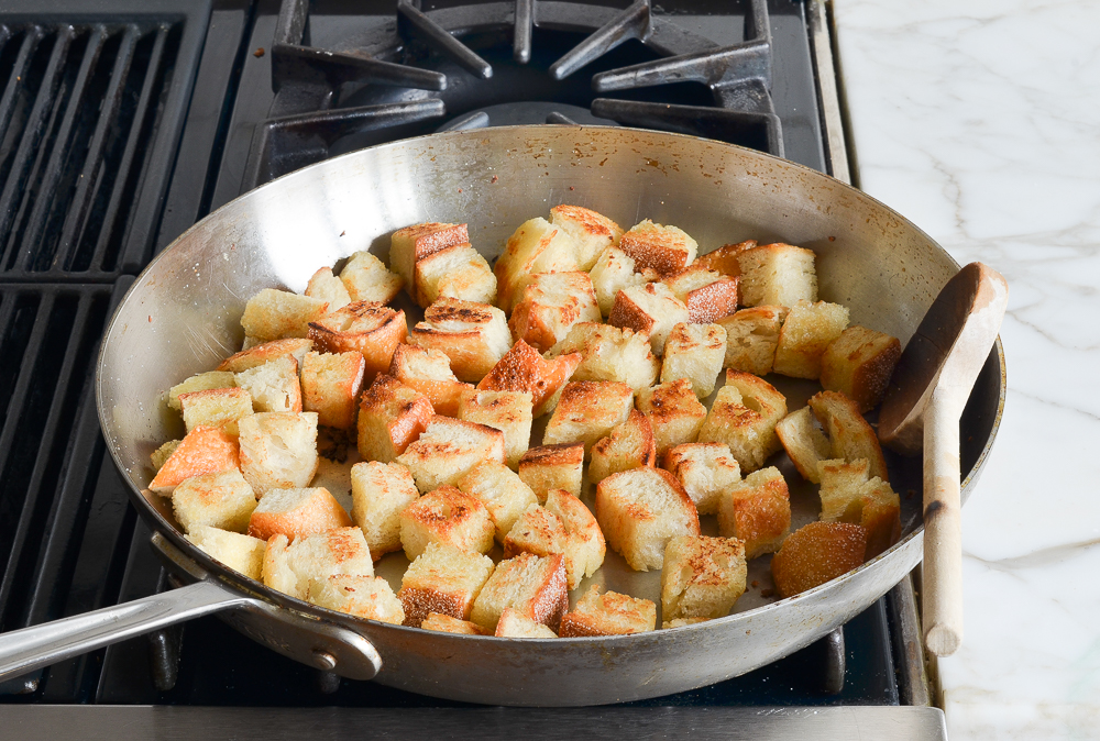 golden toasted bread cubes in skillet