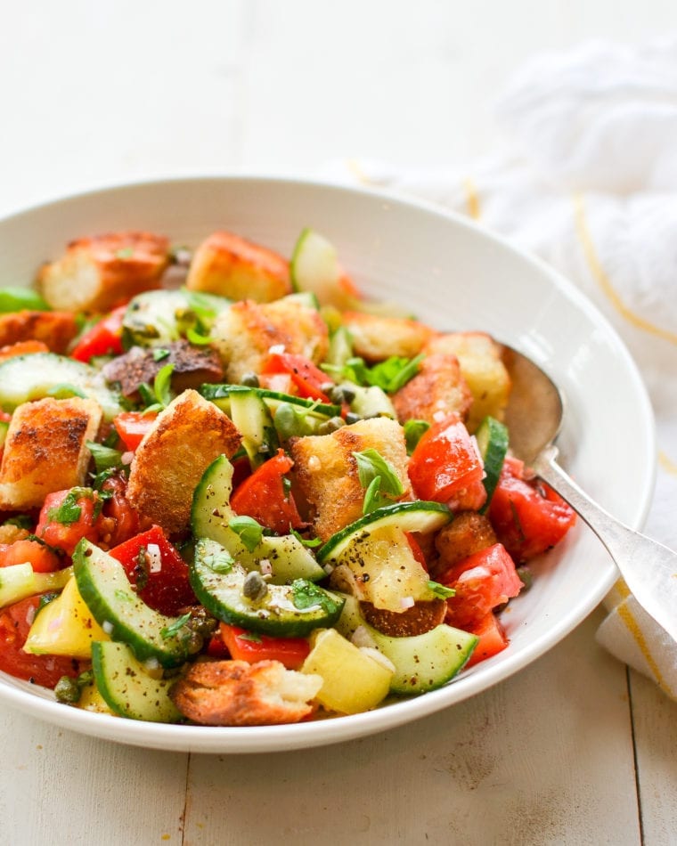 Spoon in a bowl of panzanella salad.