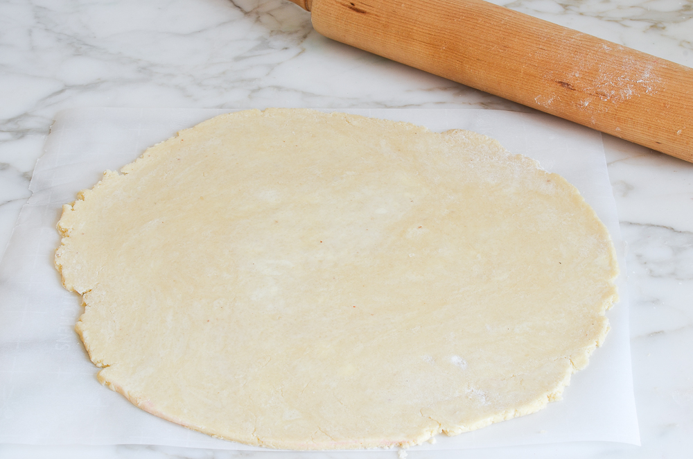 rolling galette dough on parchment