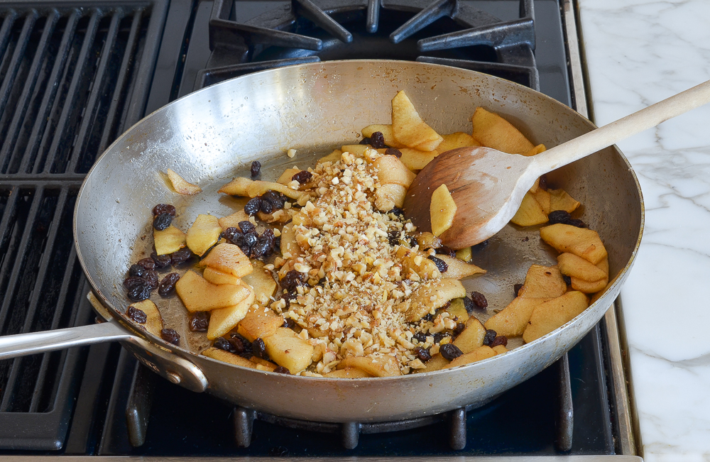 adding nuts to cooked apple mixture