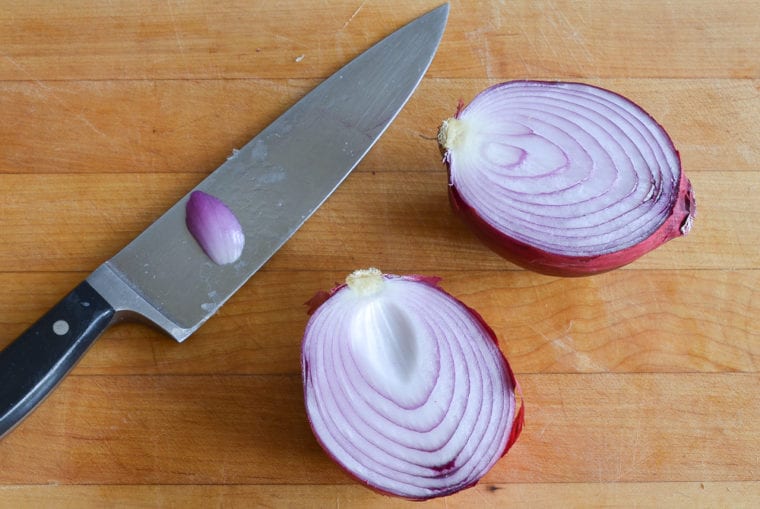 onion and knife on cutting board