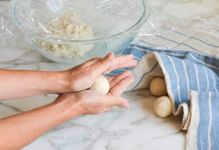 rolling the dough into balls.