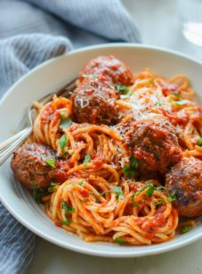 Fork in a bowl of spaghetti and meatballs.