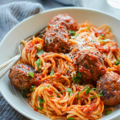 Fork in a bowl of spaghetti and meatballs.