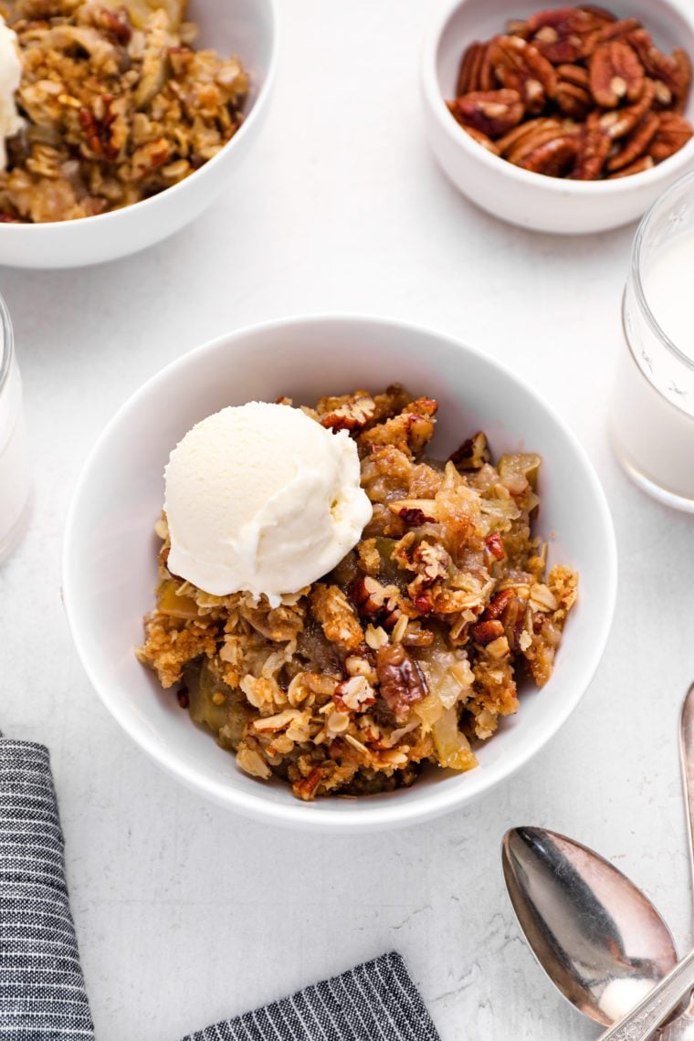 bowl of apple crisp with vanilla ice cream