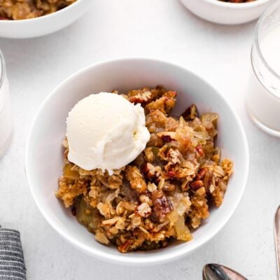 bowl of apple crisp with vanilla ice cream