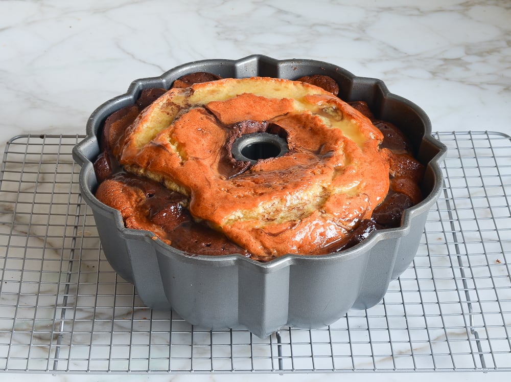 glazed marble cake resting on rack 