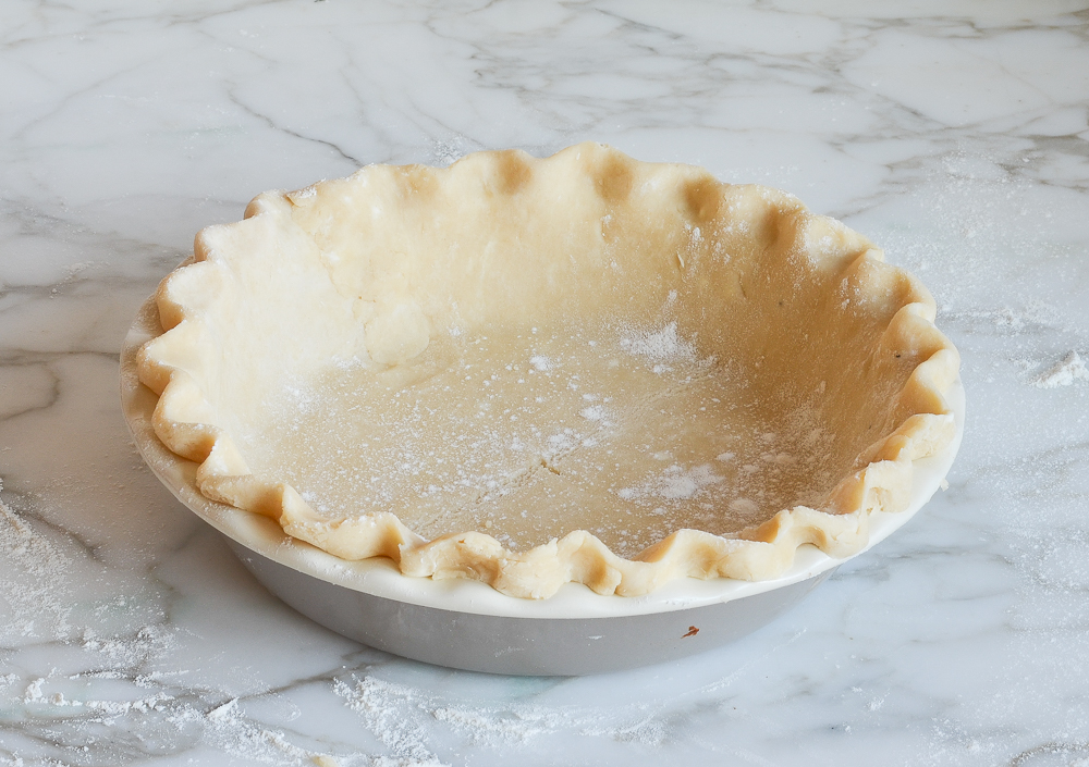 Crimped pie crust in a pie pan.