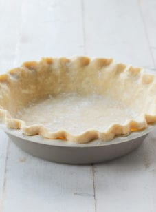 Fluted pie crust in a pie pan.