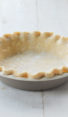 Fluted pie crust in a pie pan.