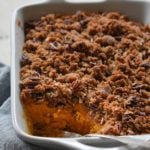 Sweet potato casserole with a scoop missing.