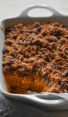Sweet potato casserole with a scoop missing.