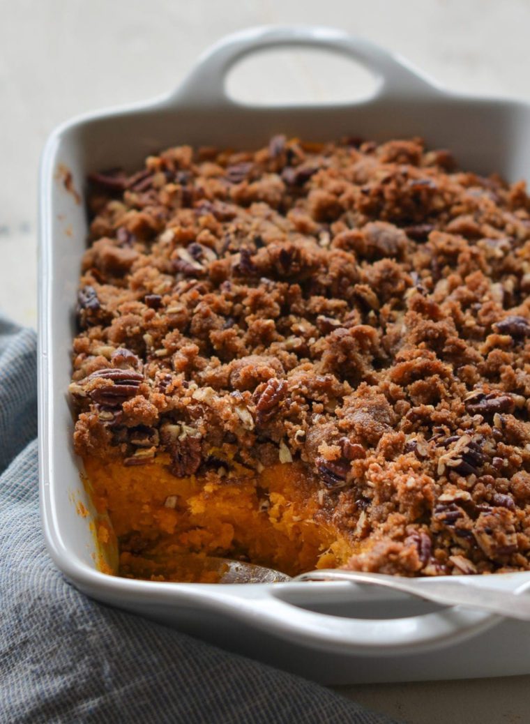 Sweet potato casserole with a scoop missing.