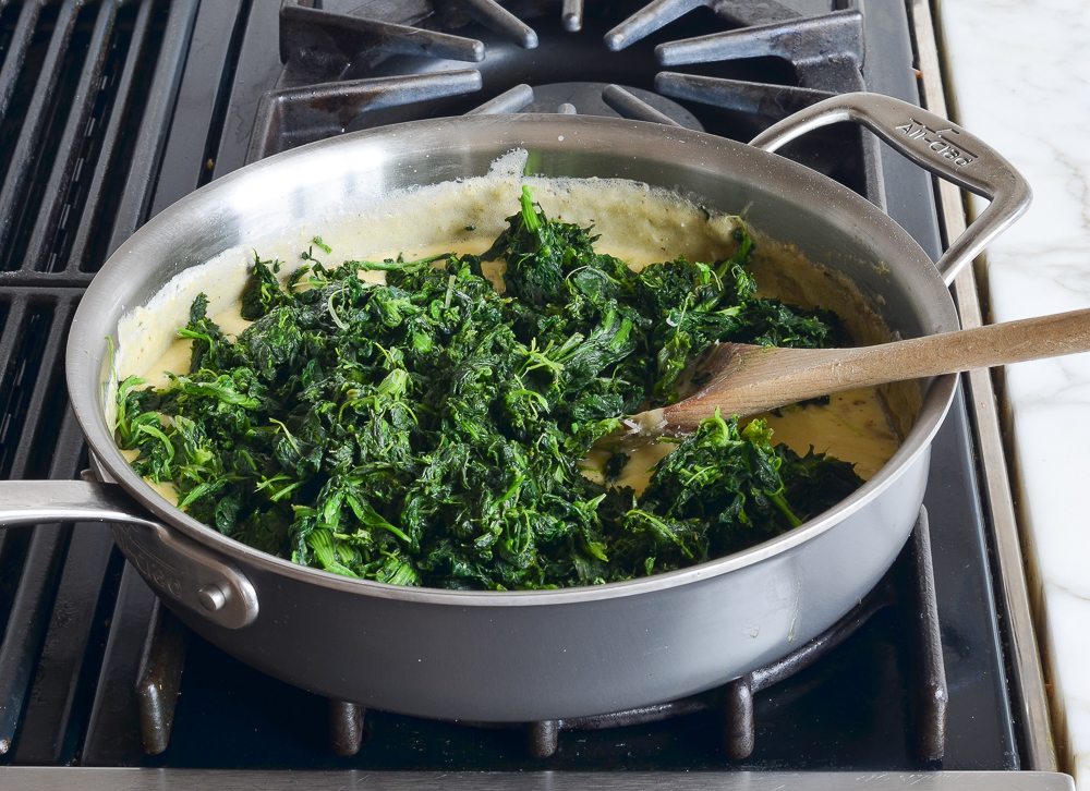 adding spinach to sauce