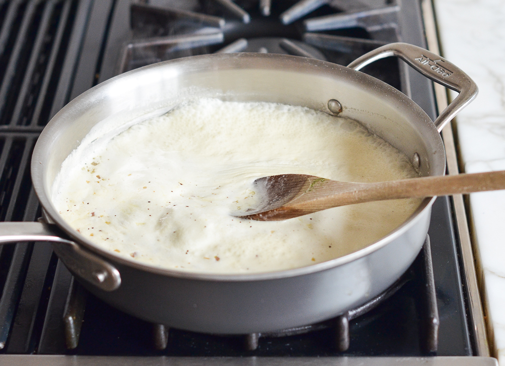 Cream boiling in a skillet.