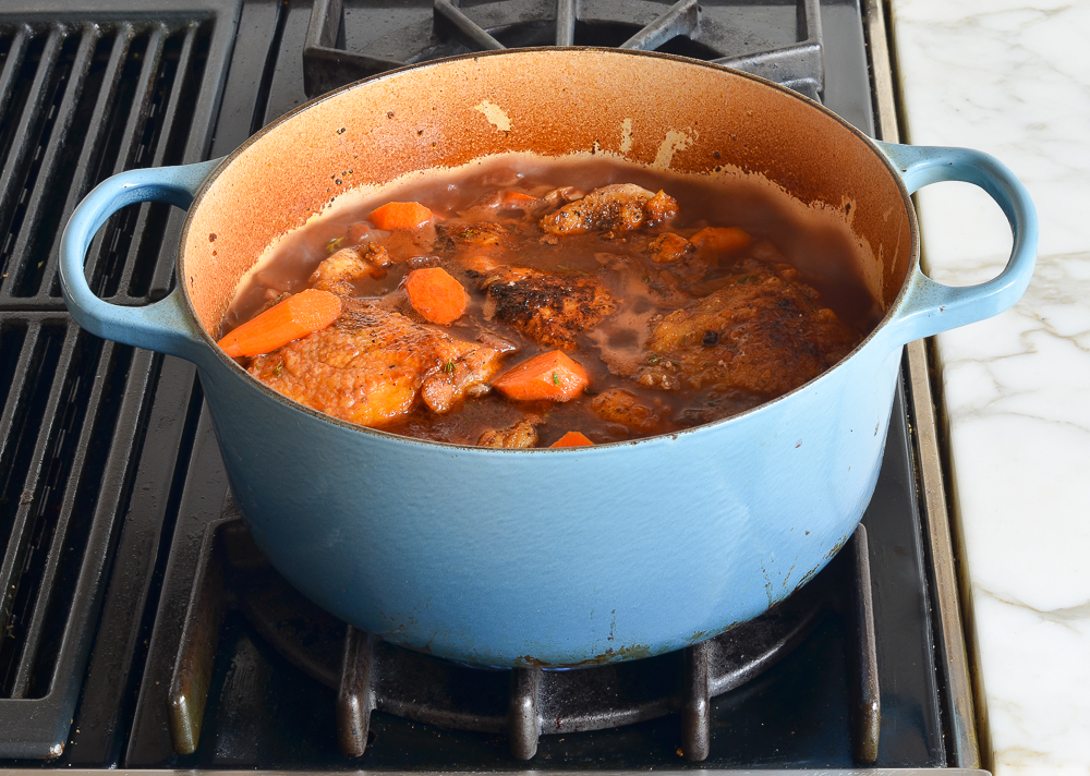 adding chicken and carrots to pot