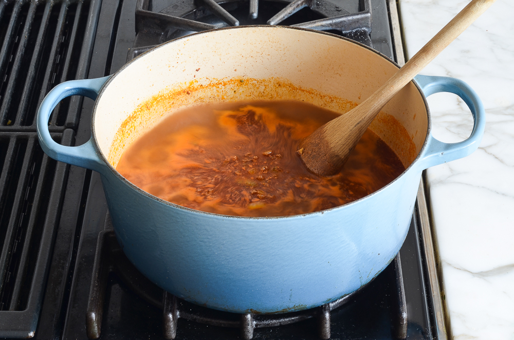 bringing the chili mac to a simmer