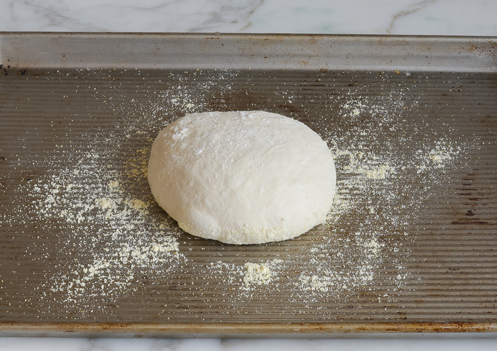letting the bread dough rest on a baking sheet