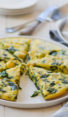 Sliced spinach frittata on a plate.
