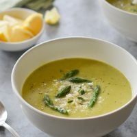 Bowl of asparagus soup with lemon and parmesan.