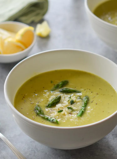 Bowl of asparagus soup with lemon and parmesan.