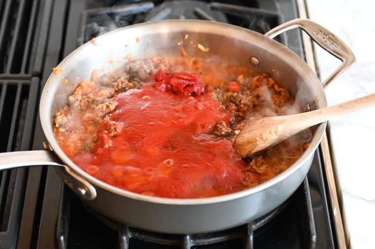 adding the tomato sauce, tomato paste, Worcestershire sauce and hot sauce