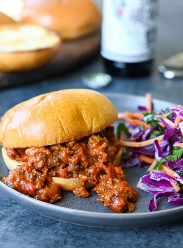 Sloppy joe on a plate with salad.