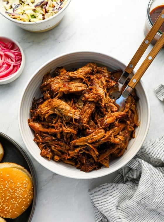 pulled pork with buns, coleslaw, pickled onions, and BBQ sauce