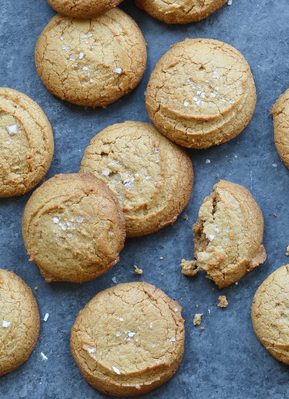Flourless peanut butter cookies, one of which is broken.