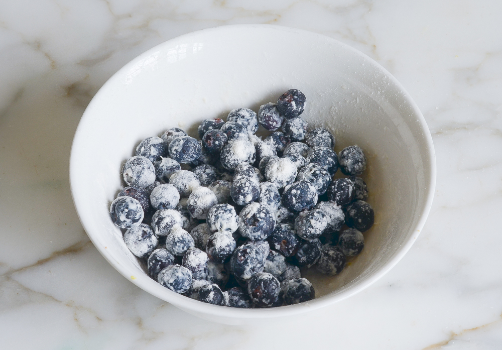 tossing blueberries with flour