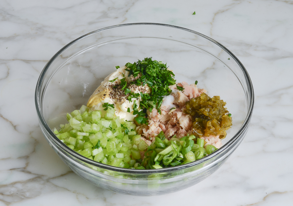 tuna salad ingredients in mixing bowl