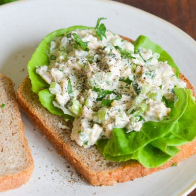 Opened tuna sandwich on a plate.