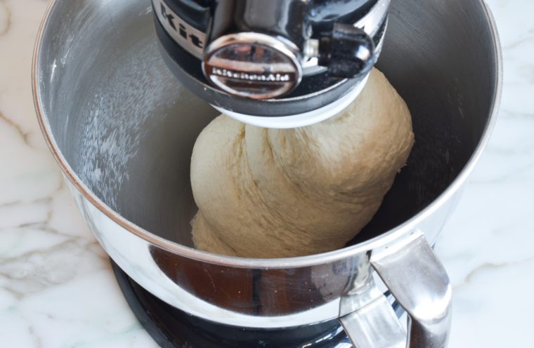 kneading pizza dough in mixer