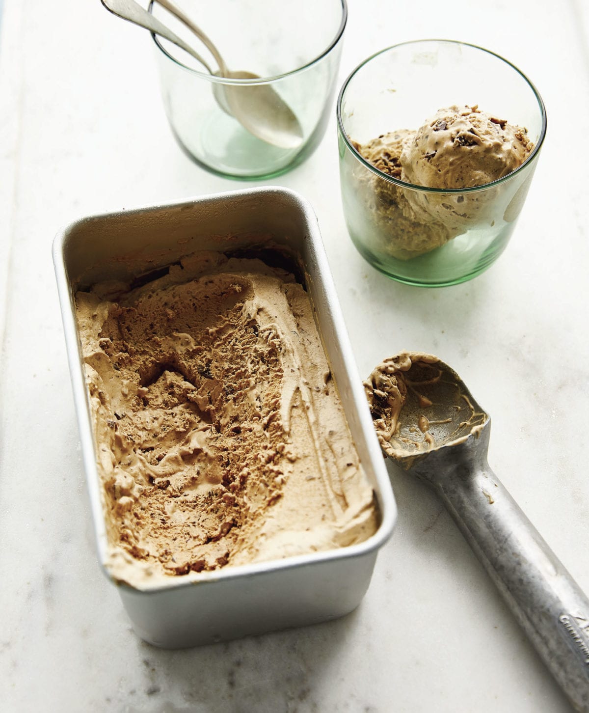 Vietnamese coffee ice cream in a glass and a metal container.