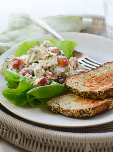 Chicken salad with grapes and almonds on lettuce.