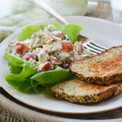 Chicken salad with grapes and almonds on lettuce.